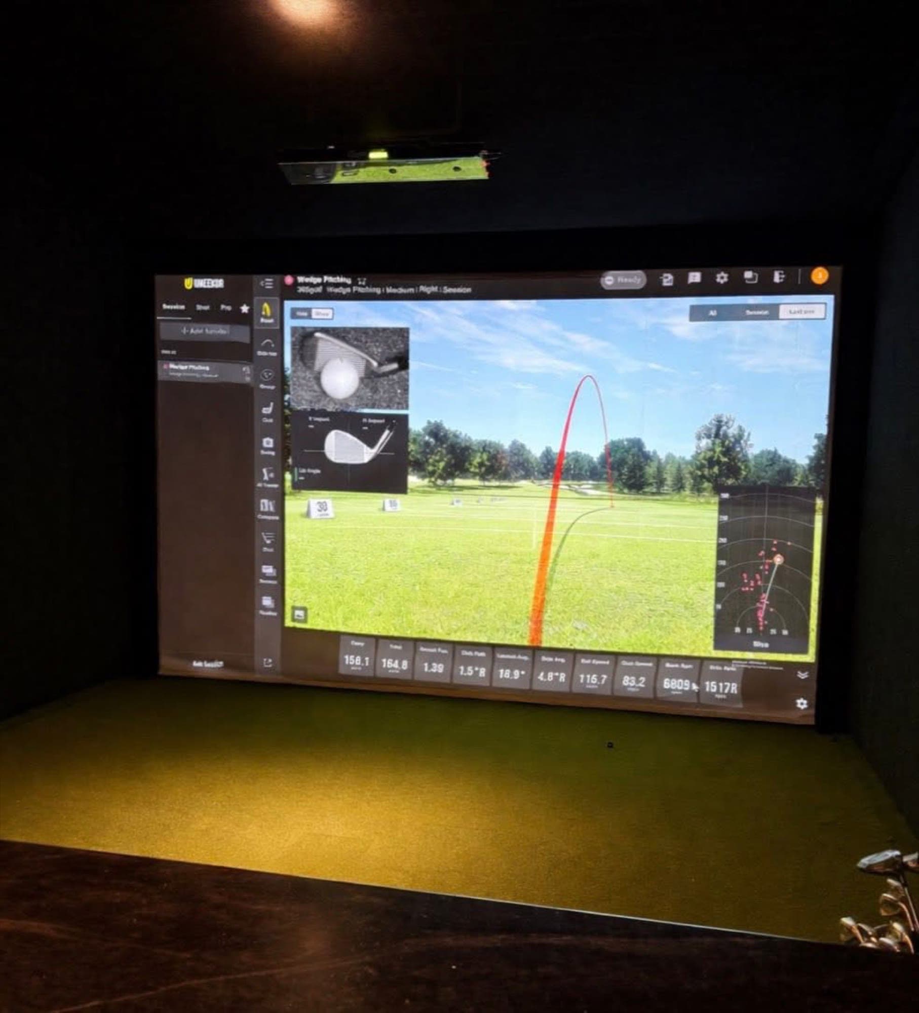 A simulator bay with a shot tracer on the screen
